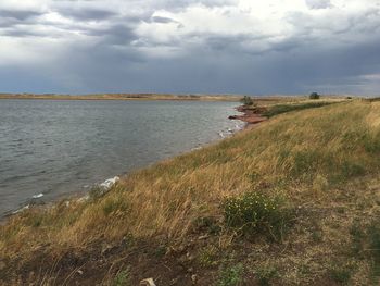 Scenic view of landscape with lake in foreground