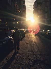 Rear view of man walking on street in city