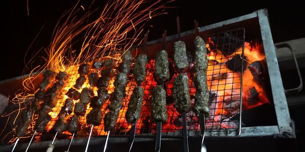 Low angle view of bonfire on barbecue grill