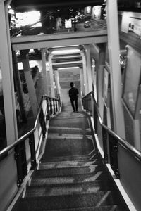 Rear view of woman walking on staircase