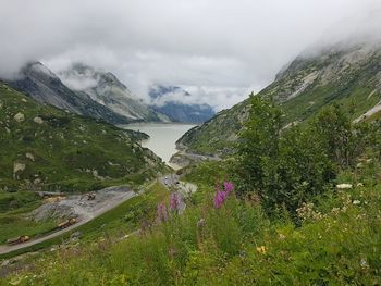 Scenic view of sea and mountains against sky