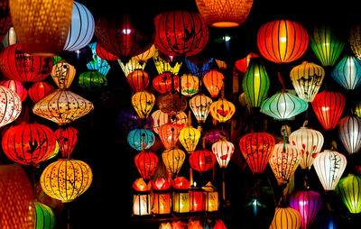 Low angle view of illuminated lanterns hanging at night