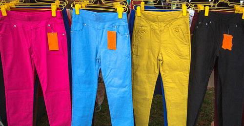 Multi colored pants hanging at store