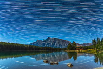 Scenic view of lake against sky at night