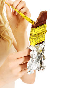 Close-up of woman holding hands over white background