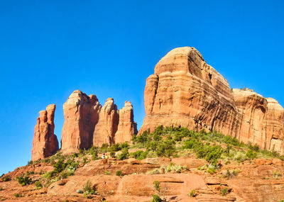 Rock formations on mountain against clear blue sky