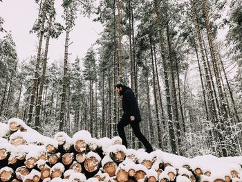 Man standing by trees against sky