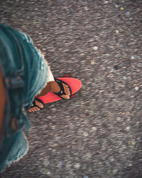 Low section of woman standing on street