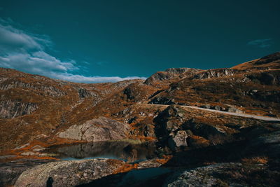 Scenic view of mountains against blue sky