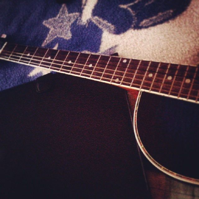 music, musical instrument, high angle view, indoors, guitar, musical instrument string, night, arts culture and entertainment, musical equipment, shadow, close-up, no people, part of, still life, dark, metal, acoustic guitar, table, elevated view, string instrument