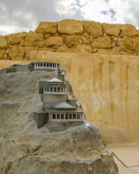 Built structure on rock against sky