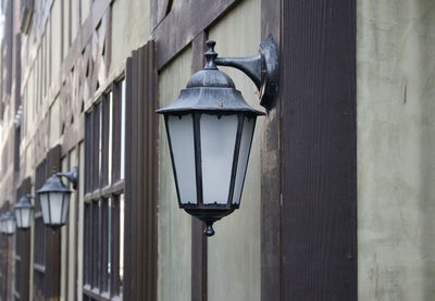 Old iron street lantern on wooden wall