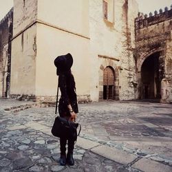 Woman standing in front of historic building