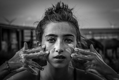 Portrait of young woman with soap sud