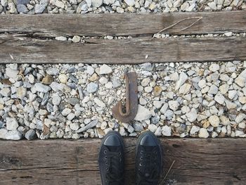 Low section of shoes standing on wood