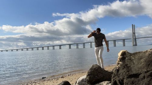 Man standing on beach against sky