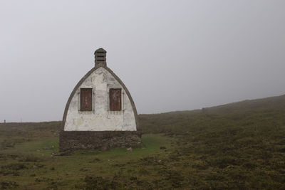 Built structure on field against clear sky