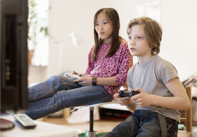 Boy and girl playing video game