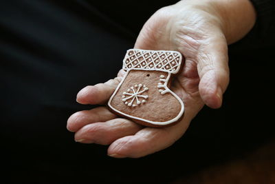 Close-up midsection of hand holding gingerbread cookie