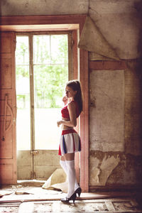 Woman standing by window