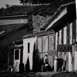 People sitting outside old building