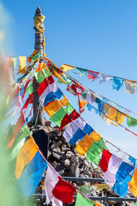 Low angle view of flags hanging against sky