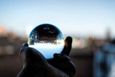 Close-up of hand holding crystal ball