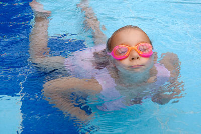 Portrait of woman swimming in pool