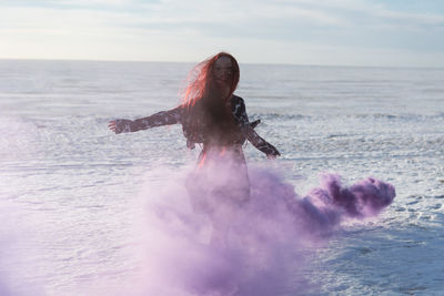 Man surfing in sea against sky