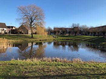 Scenic view of lake by building against sky