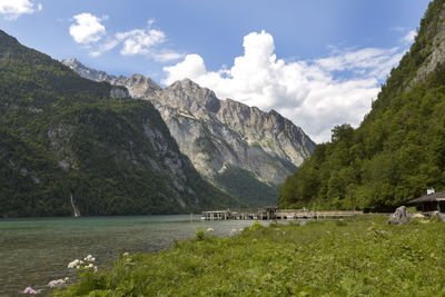 Scenic view of sea and mountains against sky