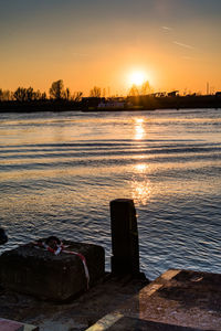 Scenic view of lake against sky during sunset