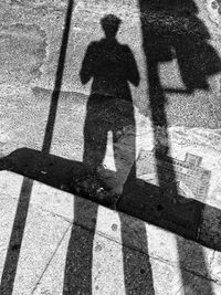 Shadow of man standing on tiled floor