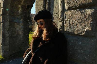 Woman standing against wall