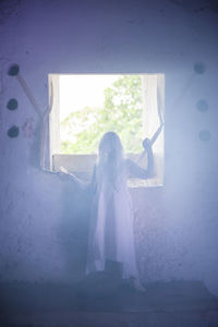 Woman tied by window in abandoned building