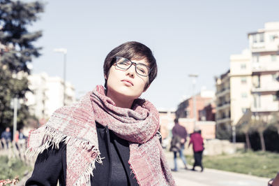 Woman standing in city against sky during winter