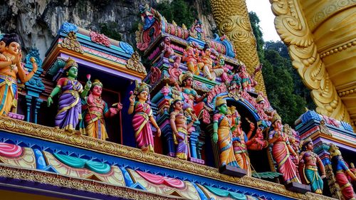 Low angle view of statues on building outside temple