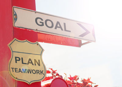 Low angle view of road sign against clear sky