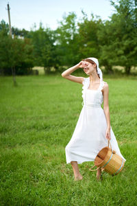 Full length of young woman on grass