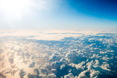 Aerial view of clouds over landscape against sky