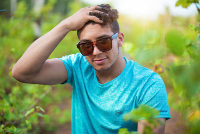 Portrait of young man wearing sunglasses standing outdoors