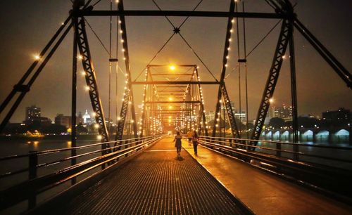 Illuminated bridge at night