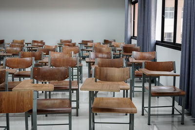 Empty chairs and table in classroom