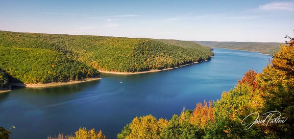 High angle view of lake and trees against sky