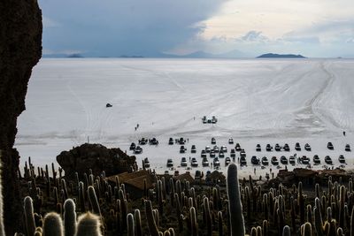 High angle view of crowd on landscape against cloudy sky