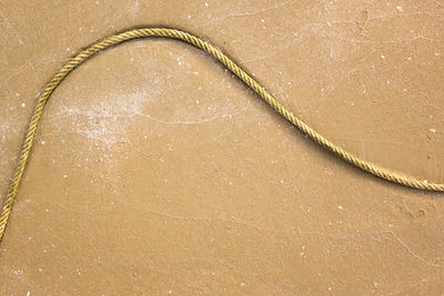 High angle view of rope on sand at beach