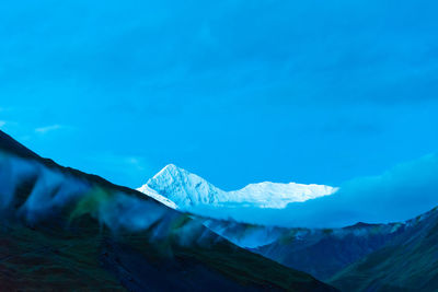 Scenic view of snowcapped mountains against sky