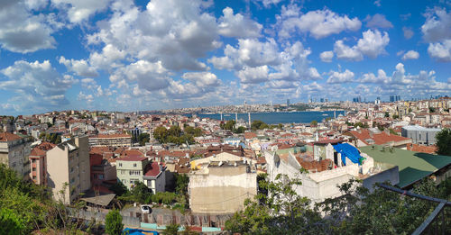 High angle view of townscape by sea against sky