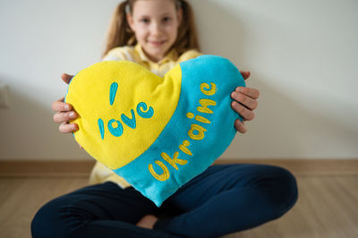 Portrait of woman holding heart shape