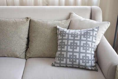 Close-up of mannequin on sofa at home